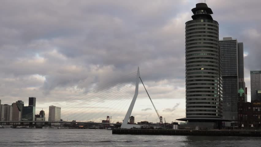 On a Moody, Cloudy Day in the Dutch City of Rotterdam some Water Taxis cross the River!