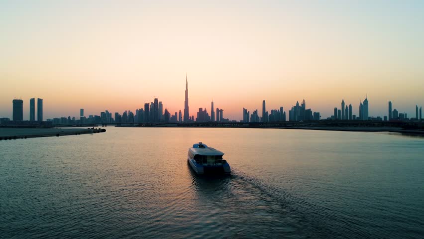 Aerial view of a yacht in the bay of Dubai during sunset, U.A.E. Royalty-Free Stock Footage #1024674230