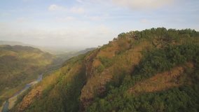 Cinematic aerial footage parallax view of MANGUNAN peak in green forest, Yogyakarta, Indonesia