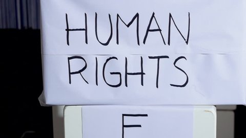 Human rights written on box. Panning. Close up.