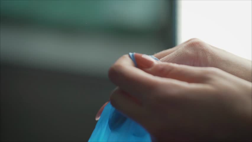 A dentist wears blue rubber gloves. Blue gloves dress doctor.. Handsome young doctor putting on rubber gloves in hospital or clinic. Royalty-Free Stock Footage #1024684937