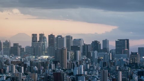Time-lapse day to night, Tokyo skyline , Shinjuku view and Mountain fuji in Japan : panning right.