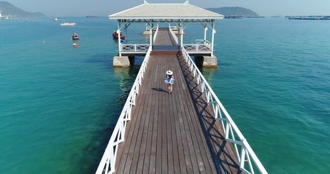 Aerial view of Tourist walking on a wood waterfront pavilion in Koh si chang island, Thailand. AsDang Bridge.