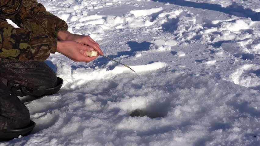 winter fishing, fishing pole hovering over the hole
