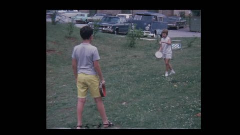 Young boy and girl play Tambourelli badminton