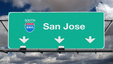 San Jose California interstate route 880 overhead freeway directional arrow sign with time lapse clouds.