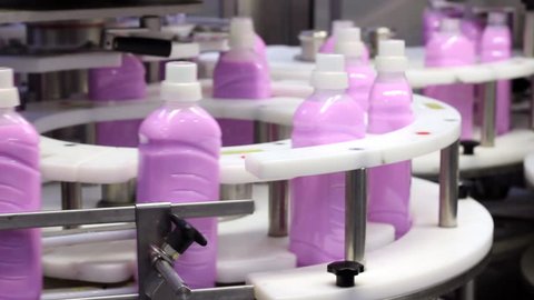 Bottles of fabric softener moving along a conveyor belt. HD 1080p .