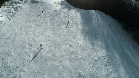 Aerial slow motion footage of downhill skiing. 4K 60fps