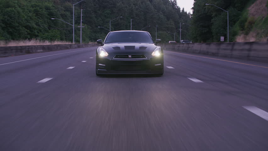Portland, OR / USA Circa 2018 - Tracking shot of sports car driving on freeway and through tunnel at dusk. | Shutterstock HD Video #1024709744