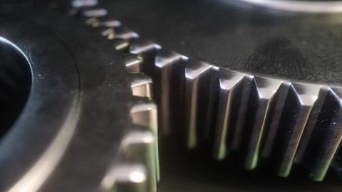 Metallic gear symbol on a dark background. 3d gear mechanism.