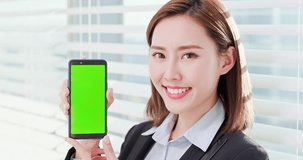 Young asian business woman show green screen with smart phone