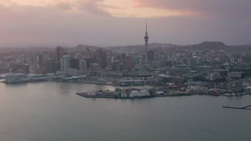Aerial: Auckland city skyline and Waitemata harbour at sunrise. New Zealand 