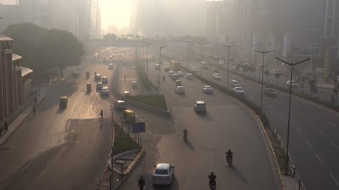 CYBER CITY, GURUGRAM, INDIA - NOV 24: Traffic and pedestrians in hazardous levels of air pollution on November 24, 2018 in Cyber City, Gurugram, India