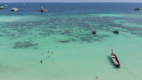 Video on the top of the blue sea, white sand beach with long tail boats sailing At Koh Lipe In the south of Thailand
