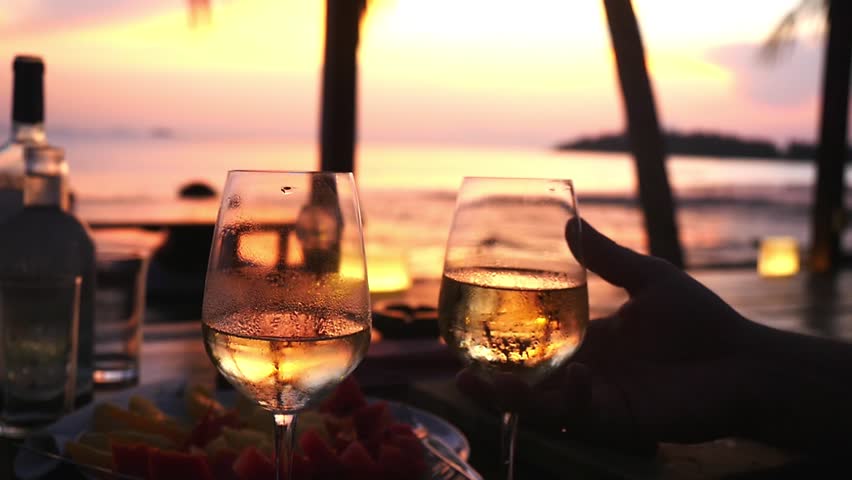 Couple takes two glasses in their hands with white wine against the sunset at the sea. slow motion, 1920x1080 | Shutterstock HD Video #1024730633