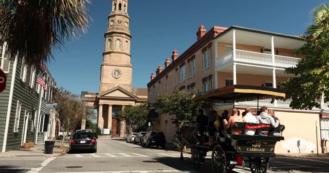 Charleston, South Carolina, USA – October 23, 2018: People take a carriage ride by St. Philip's Church in historic downtown Charleston South Carolina USA.