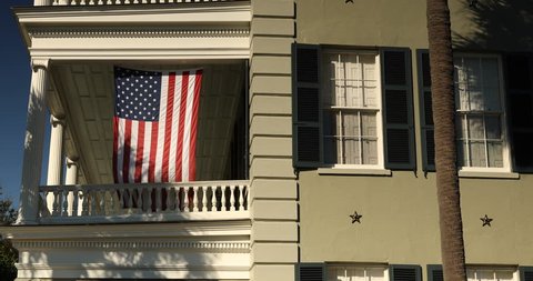 American flag hangs from a balcony in Charleston South Carolina USA