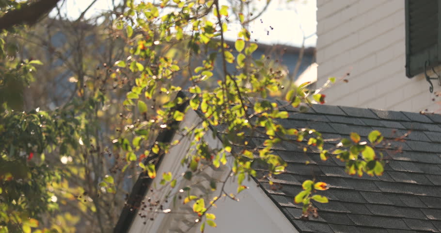 USA flag hangs from a front porch in the summer at a patriotic home in the USA