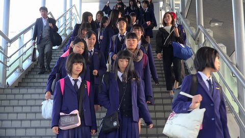 HIROSHIMA / JAPAN - NOVEMBER 2, 2018:
Goup of Japanese schoolgirls coming down the stairs at the Hiroshima train station. 