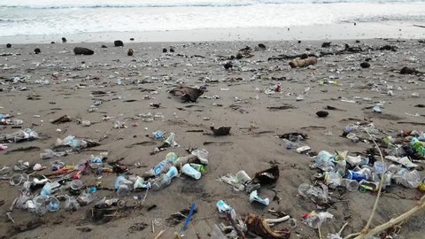 Cameraes over plastic garbage washed out to the shore from the ocean, man kind polluted the seas