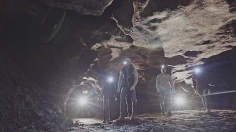 Group of speleologists exploring a cave
