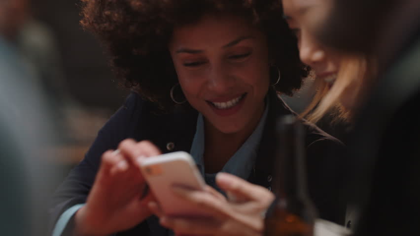 happy girl friends using smartphone in restaurant browsing social media sharing reunion party enjoying friendship chatting having fun socializing together Royalty-Free Stock Footage #1024763681