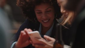 happy girl friends using smartphone in restaurant browsing social media sharing reunion party enjoying friendship chatting having fun socializing together - Powered by Shutterstock - Get 15% off with code: PIKWIZARD15