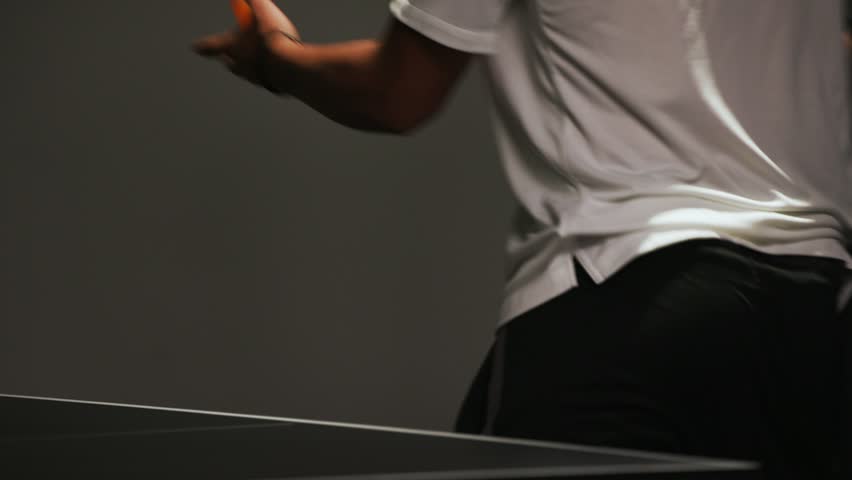 Close up of hands playing ping pong.
