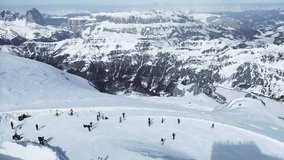 4k video with panoramic view of skiers and cable car seen from the top of Marmolada peak, the highest mountain peak of the Dolomites range.