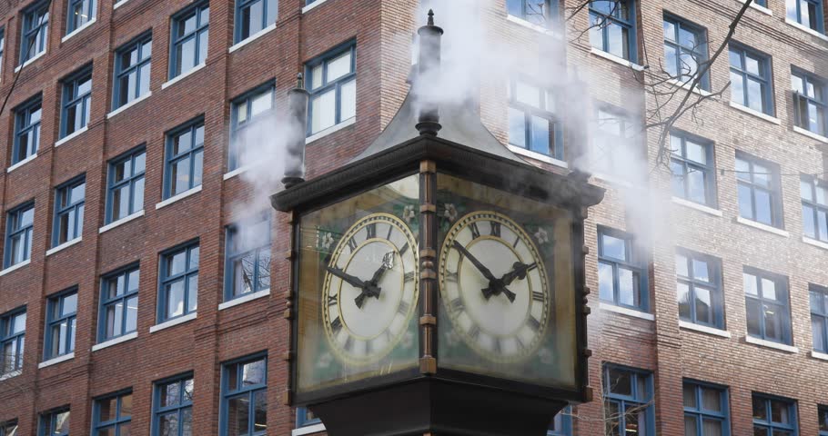 A close-up of Gastown Steam Clock blowing steam during windy weather