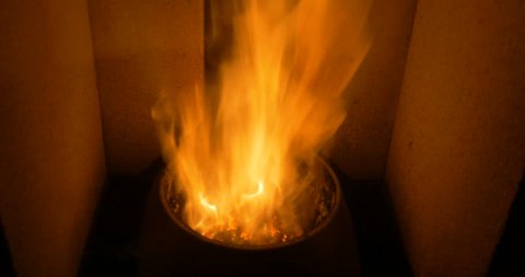 pellets burning in stove, ecological friendly boiler making hot hair for all the house. fireplace and clean energy 