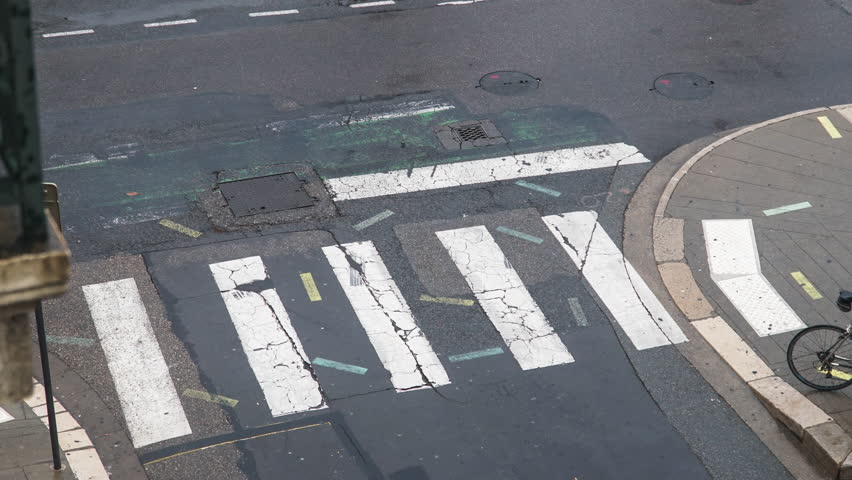 Time lapse of the street, focus on a pedestrian crossing, on a rainy day in the center of Grenoble, french town close to the french alps.
