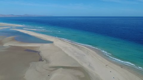 Flying over empty sandy beaches on low tide. Shot taken on Sotavento beach, Fuerteventura, Canary Islands. February 2019.