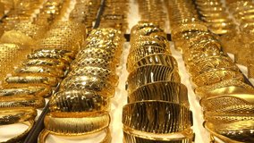 Rows of golden rings close-up on the counter of a jewelry store. HD video