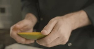 Chef reveals the hands diced mango. 4K slow motion video
