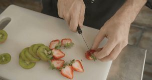 ?hef cuts the cake in half with sharp knife. 4k slow motion video