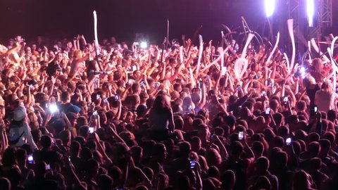 Kiev, Ukraine - September 15, 2018: Many spectators in front of the stage wave their hands at the music festival "FreeFestSoloma". Music fans in front of the stage at a concert.

