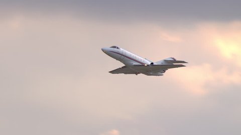 Generic Unmarked Executive VIP Celebrity Business Jet Taking off Into a South Florida Orange Sky