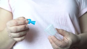 Transparent reservoir for medication in hand. Medical instrument. Human health. Video in 4K