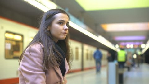 Nervous young female suffering anxiety attack on subway station, suicide attempt