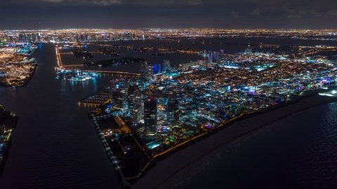 MIAMI, FLORIDA, USA - JANUARY 2019: Aerial hyperlapse 4k drone panorama view flight over Miami at night. Dodge Island and South Pointe from above.