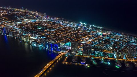 MIAMI, FLORIDA, USA - JANUARY 2019: Aerial hyperlapse 4k drone panorama view flight over Miami at night. Roads and streets from above.