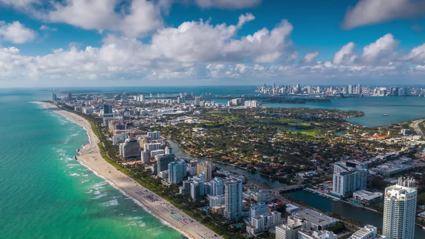 MIAMI, FLORIDA, USA - JANUARY 2019: Aerial hyperlapse 4k drone panorama view flight over South Miami and Mid-Beach ocean coastline. Miami Beach Boardwalk from above at sunny day.