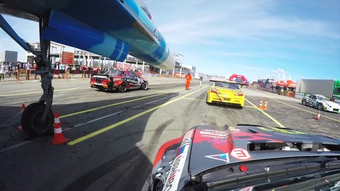 VLADIVOSTOK, RUSSIA - SEPTEMBER 16, 2018: Great go pro view, sport car drives along the track after other cars at drifting International race, Asia Pacific D1 Primring GP