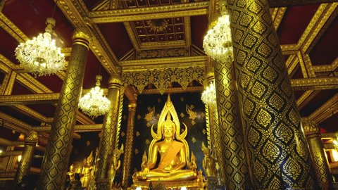 PHITSANULOK / THAILAND - FEBRUARY 16, 2019 : Panning shot of Phra Buddha Chinnarat, The most beautiful golden buddha at Wat Phra Si Rattana Mahathat in Phitsanulok province of Thailand