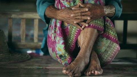 Feet of older asian women in home