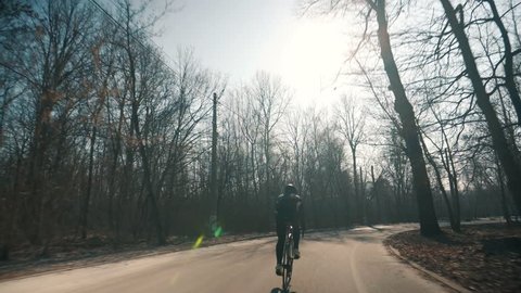 Professional Cyclist Riding Bike Fast.Professional Cyclist Ride On Road Bike. Cycling On Bicycle.Healthy Man Cycling Road Bicycle Outdoors Fitness Steadicam Shot.Active man Riding On Bicycle In Nature
