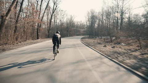 Professional Cyclist Riding Bike Fast.Professional Cyclist Ride On Road Bike. Cycling On Bicycle.Healthy Man Cycling Road Bicycle Outdoors Fitness Steadicam Shot.Active man Riding On Bicycle In Nature
