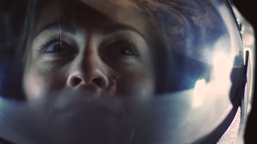 Portrait Shot of the Courageous Female Astronaut  Wearing Helmet in Space, Looking around in Wonder. Space Travel, Exploration and Solar System Colonization Concept. Royalty-Free Stock Footage #1024871762