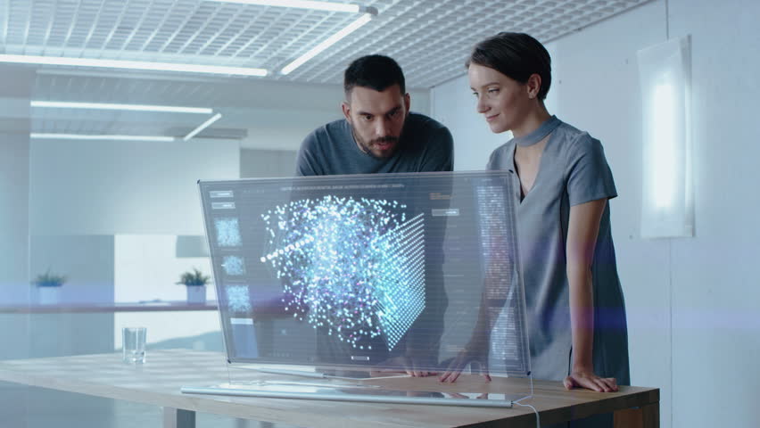 Futuristic Concept: Male and Female Computer Engineers Talk While Working on the Holographic Display Computer. Screen Shows Interactive Neural Network, Artificial Intelligence Project, User Interface Royalty-Free Stock Footage #1024871870